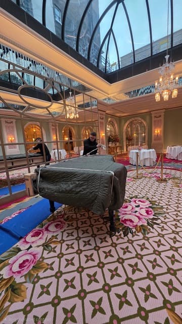 Grand piano being positioned in a hotel banquet hall