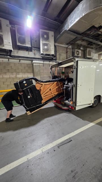 Grand piano loaded onto a JJS Pianos transport vehicle